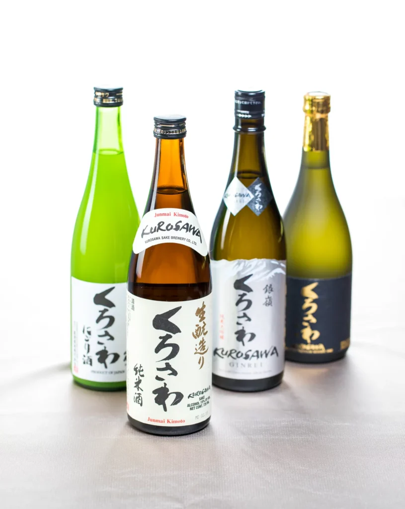 Four bottles of Japanese sake on white background.