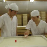 Chefs making traditional Japanese rice in the kitchen.